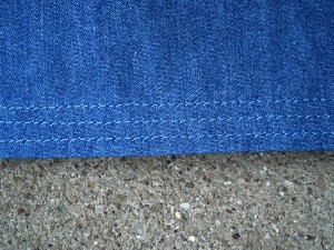 Hem - interfaced with 5/8'  strip of fusible tricot, then folded, pressed, and 3x to-stitched.